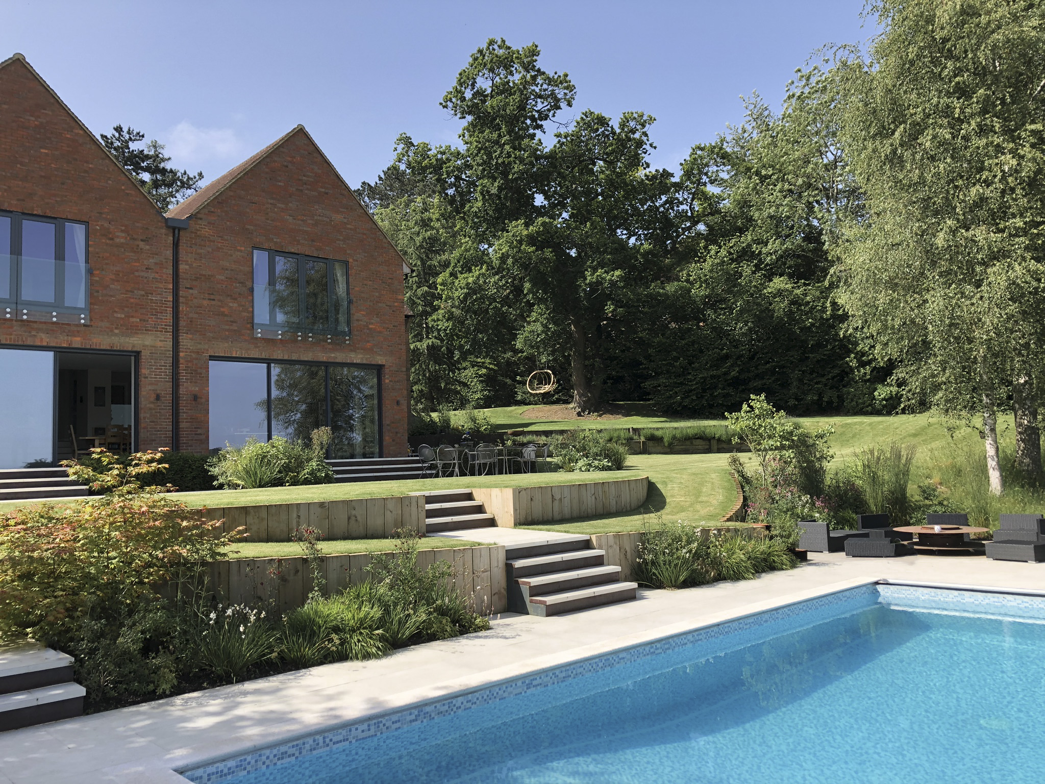 Family home tiered garden design with swimming pool
