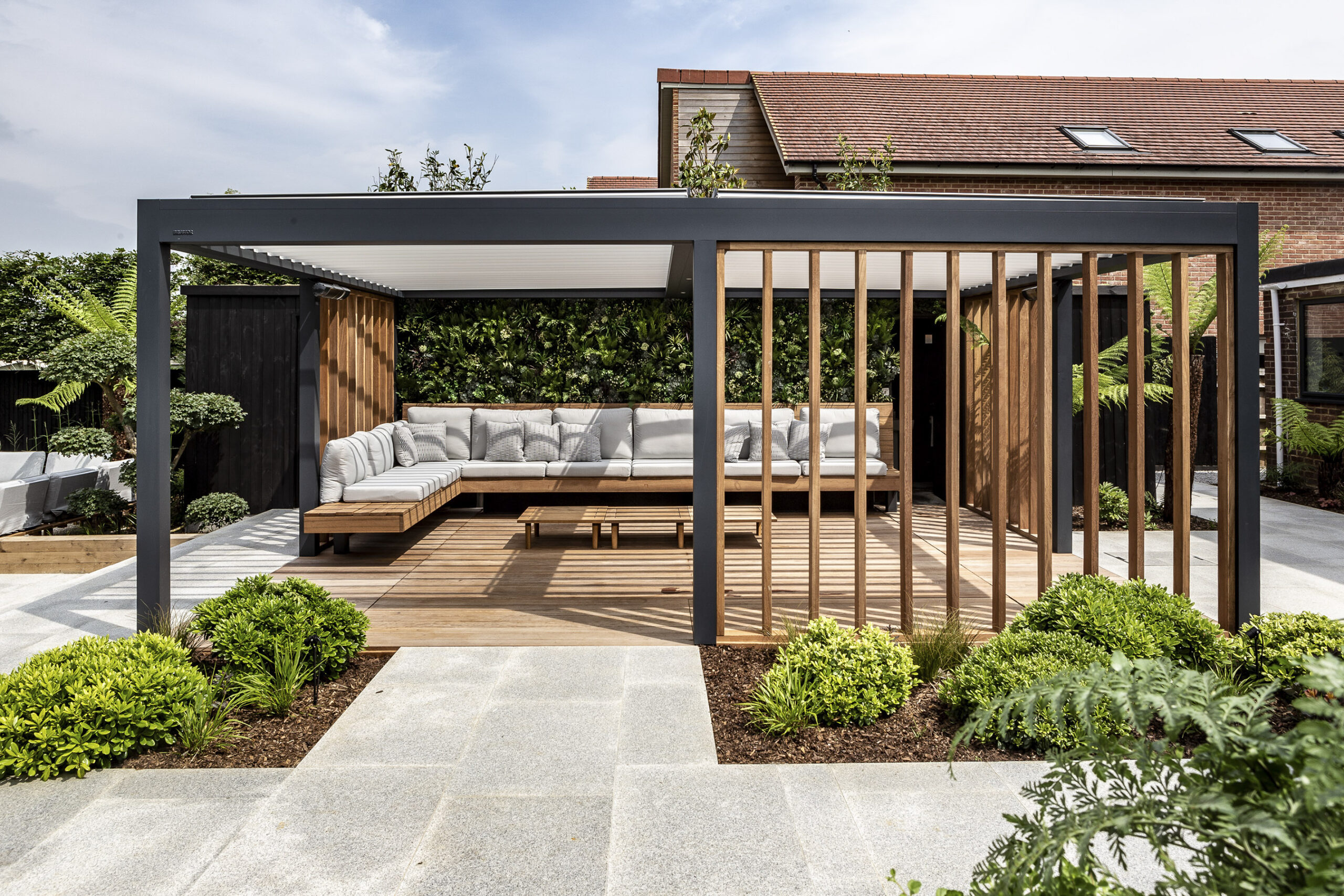 Beautiful timber garden pergola with floating cantilevered bench design