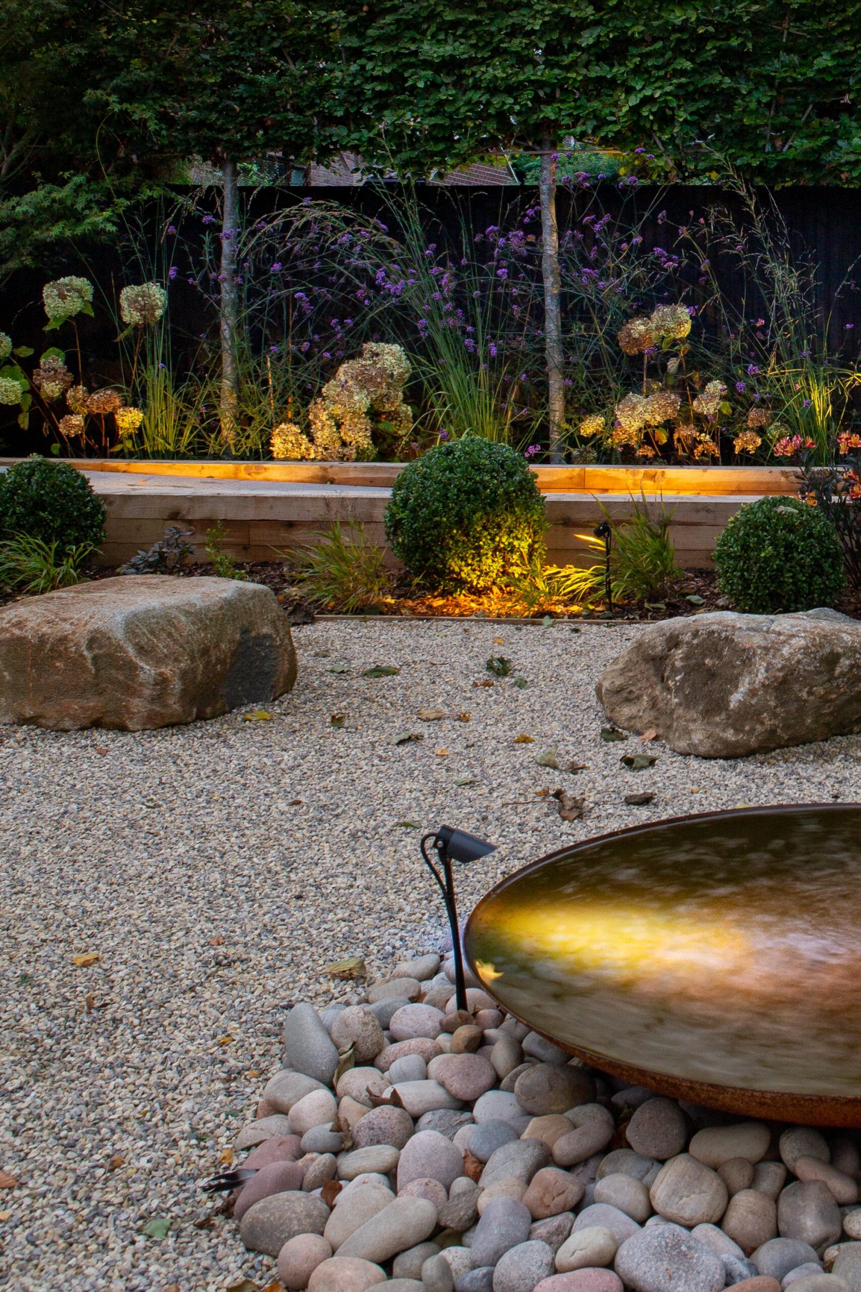Modern garden design with lighting and water feature