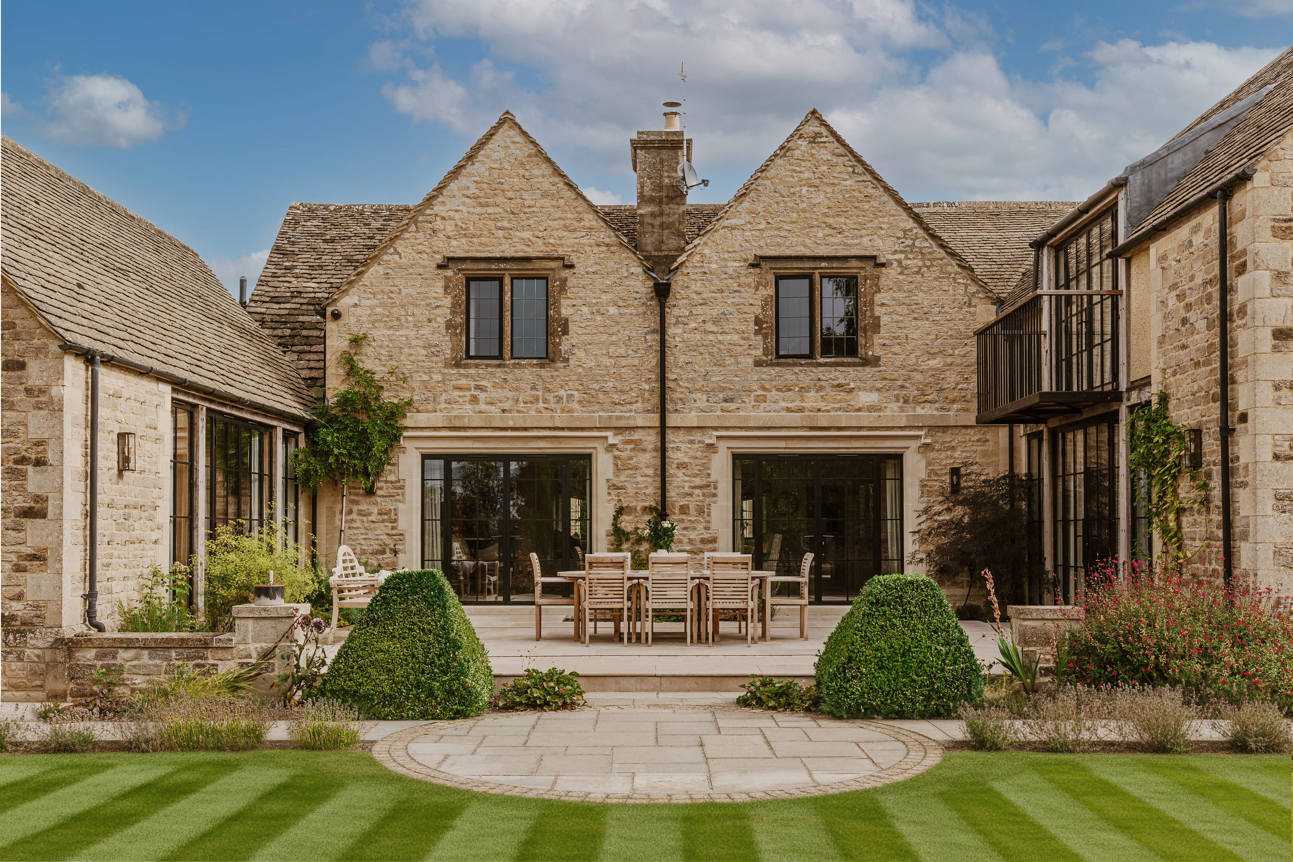 The traditional stone facade of Rosewood Manor, a sensitively restored Cotswolds country home by HollandGreen.